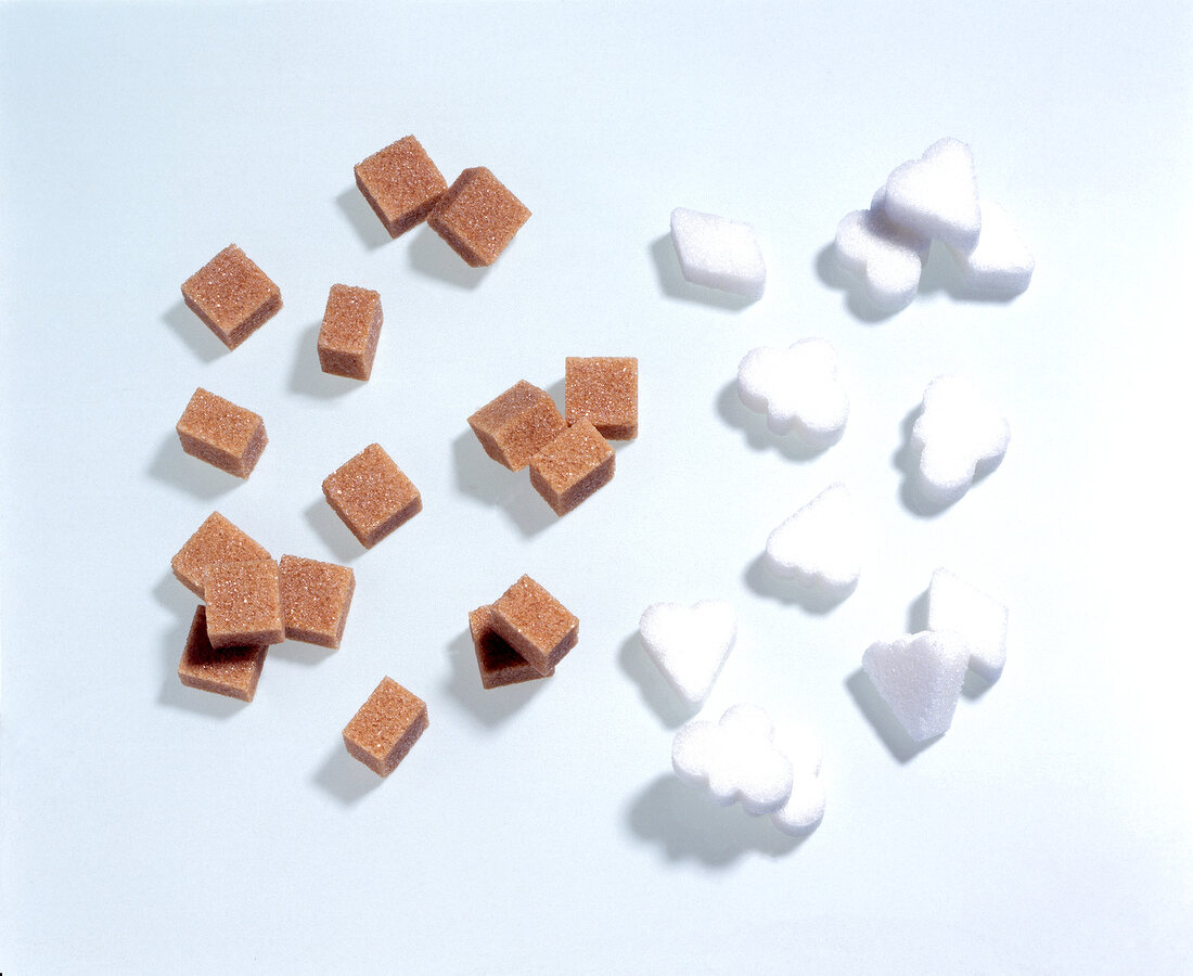 Brown and white sugar cubes on white background