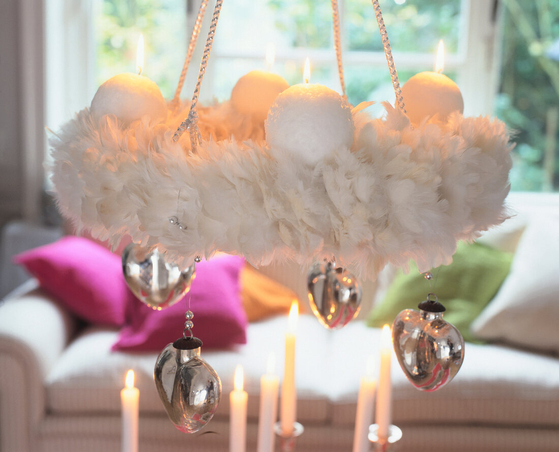 Wreath of white feathers with ball candles and silver hearts