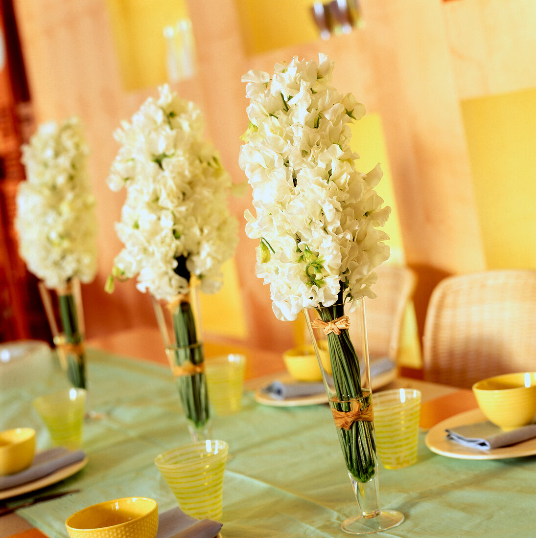 Clustered white sweet peas in champagne flutes