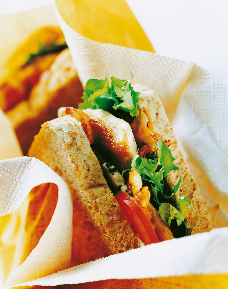 Close-up of sandwich with fried chicken breast, bacon and lettuce