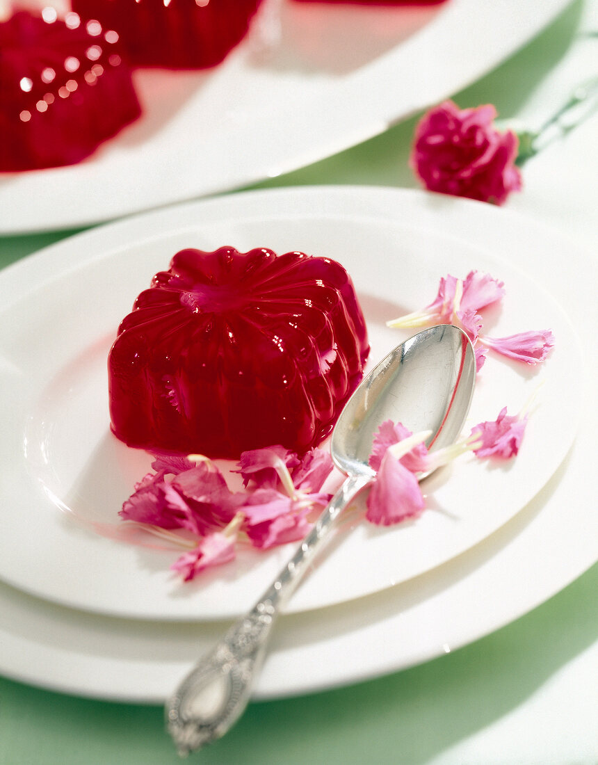 Red rhubarb jelly garnished with carnation flower