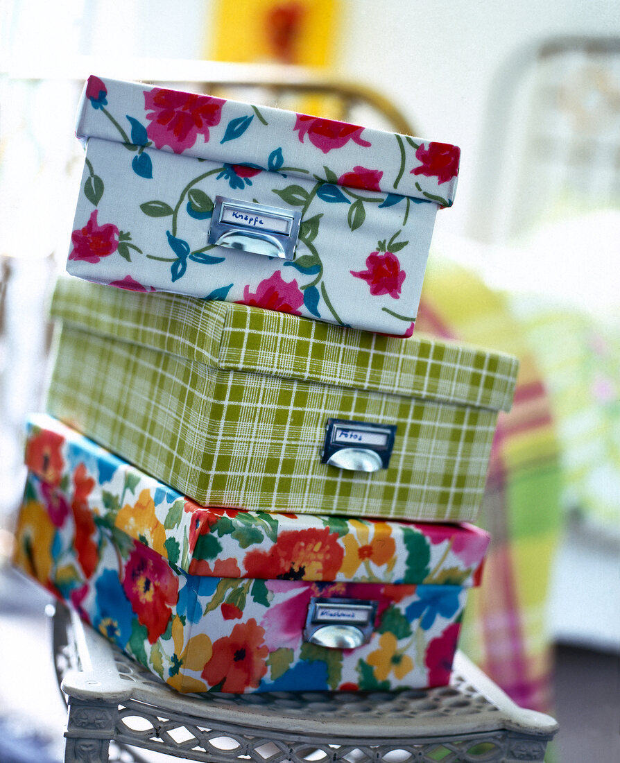 Stack of cardboard boxes covered with colourful fabric