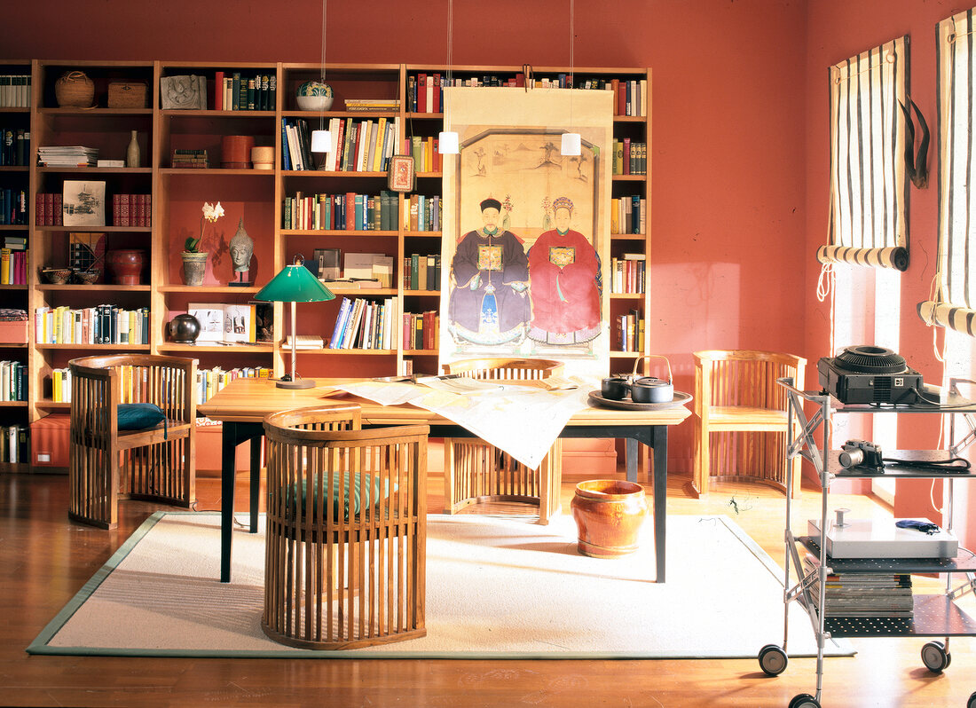 Asian-style study room with teak chairs, large table and book shelves