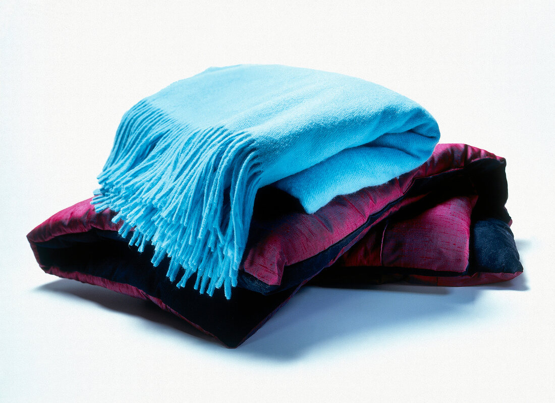 Stack of meditation mats on white background