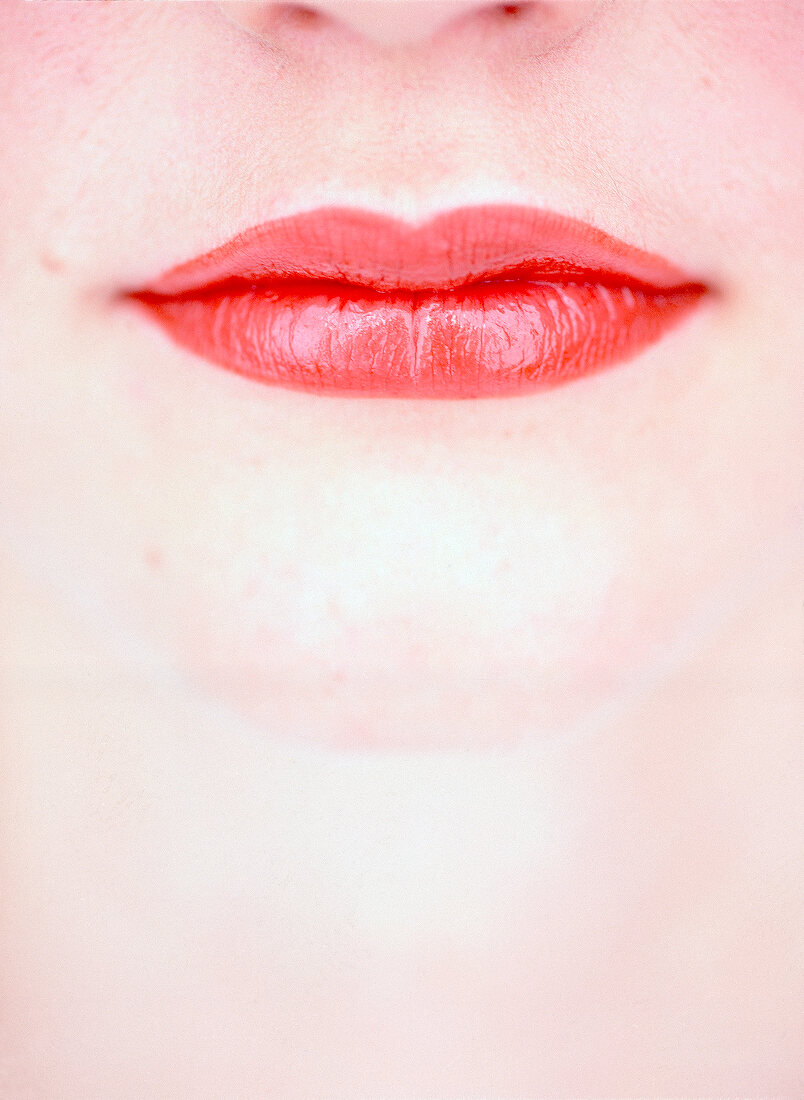 Extreme close-up of woman wearing red lipstick