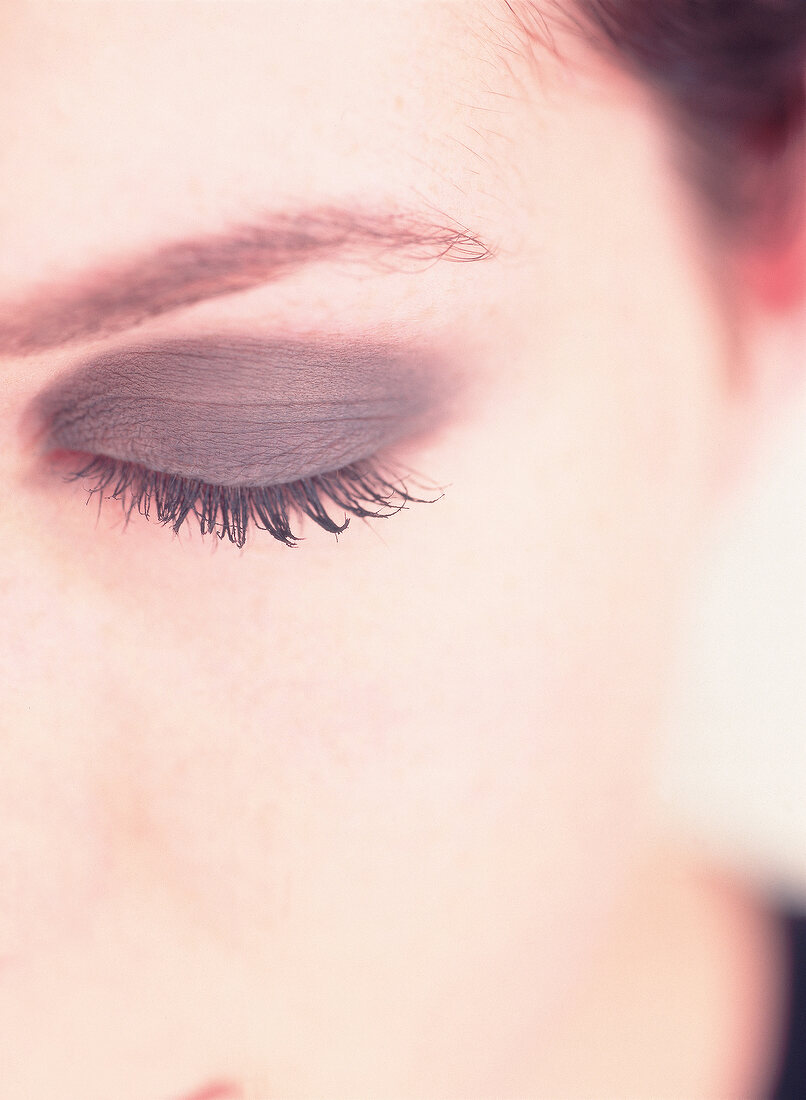 Extreme close-up of woman's eye wearing anthracite eye shadow
