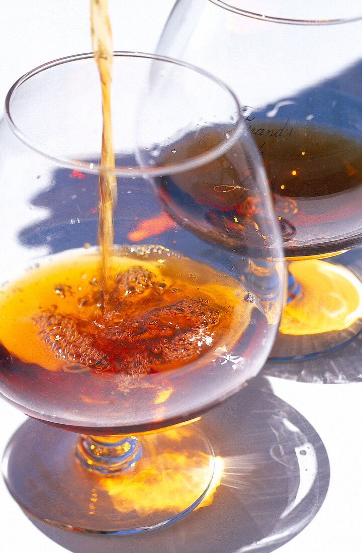 Close-up of brandy being poured into a snifter