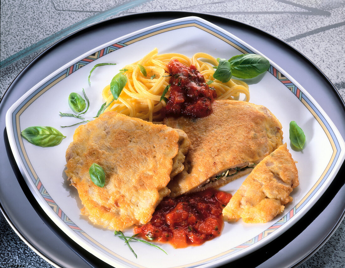 Schnitzel with mushroom filling on white square plate