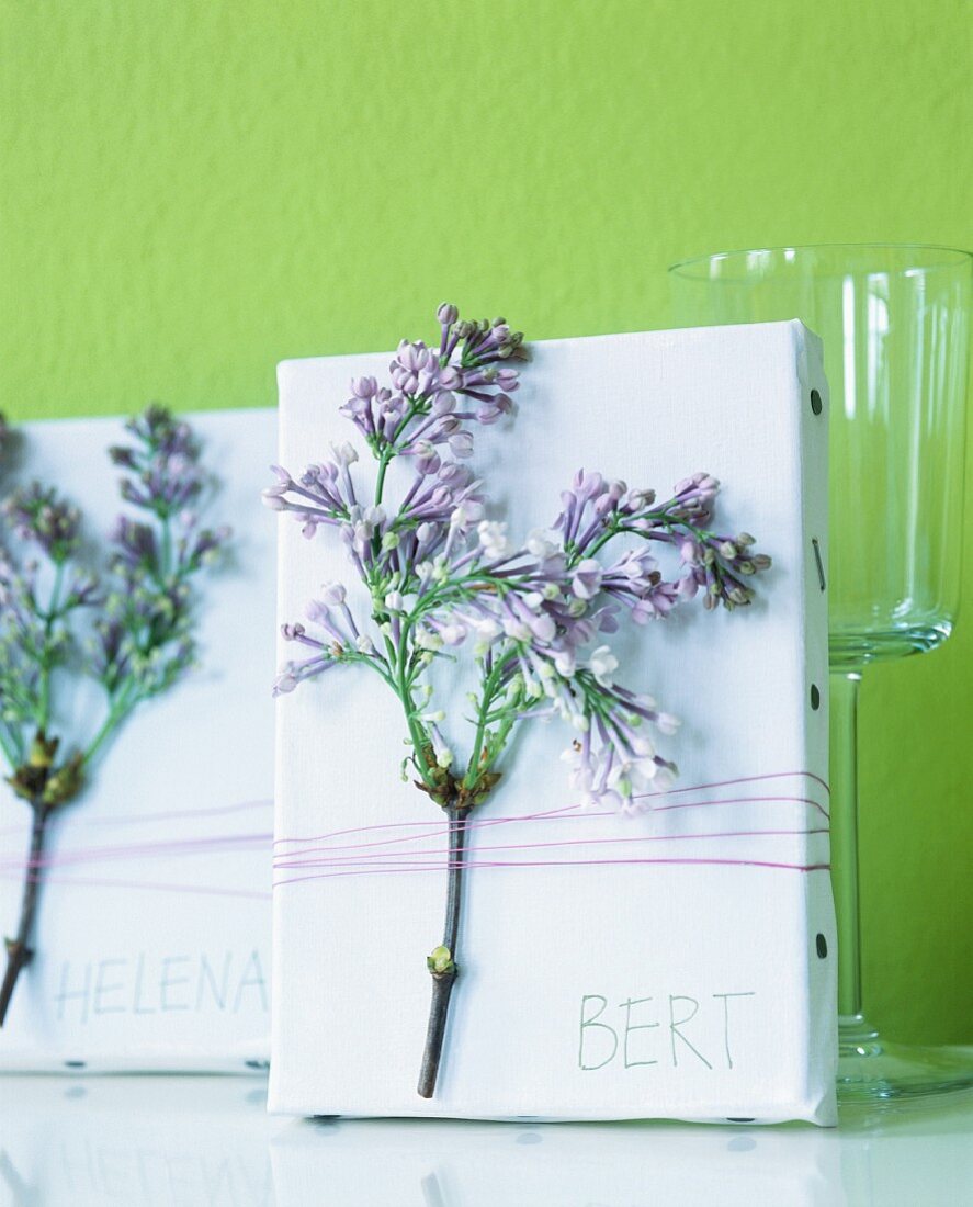 Sprigs of flowers tied to canvases as place cards