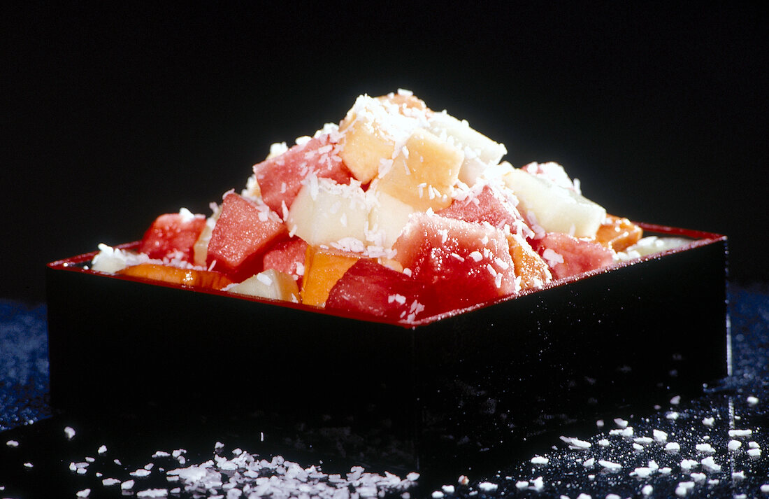 Various pieces of melon and coconut served on plate