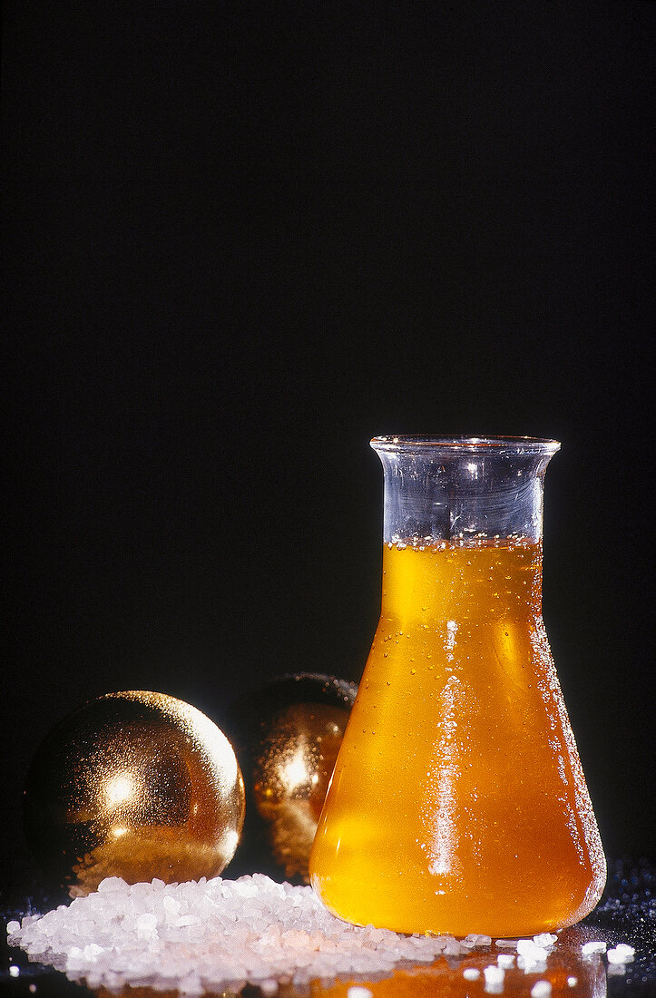 Close-up of honey water solution with sea salt and massage ball for pedicure