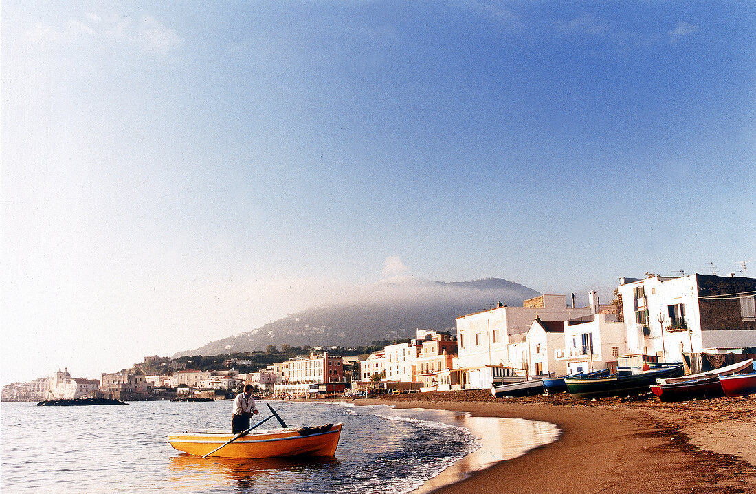 Fischer im Boot vor Stadtpanorama Vulkan im Hintergrund   -  ISCHIA