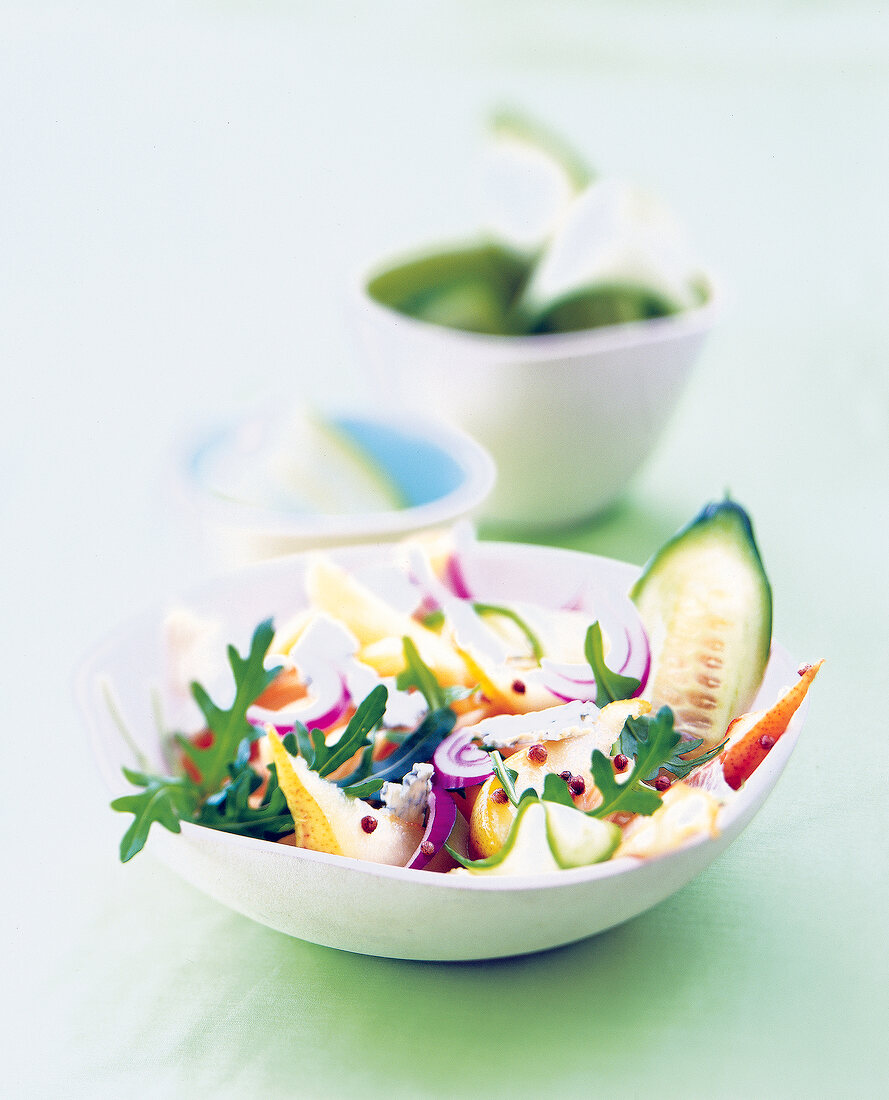 Noodle arugula salad with coriander pears in bowl