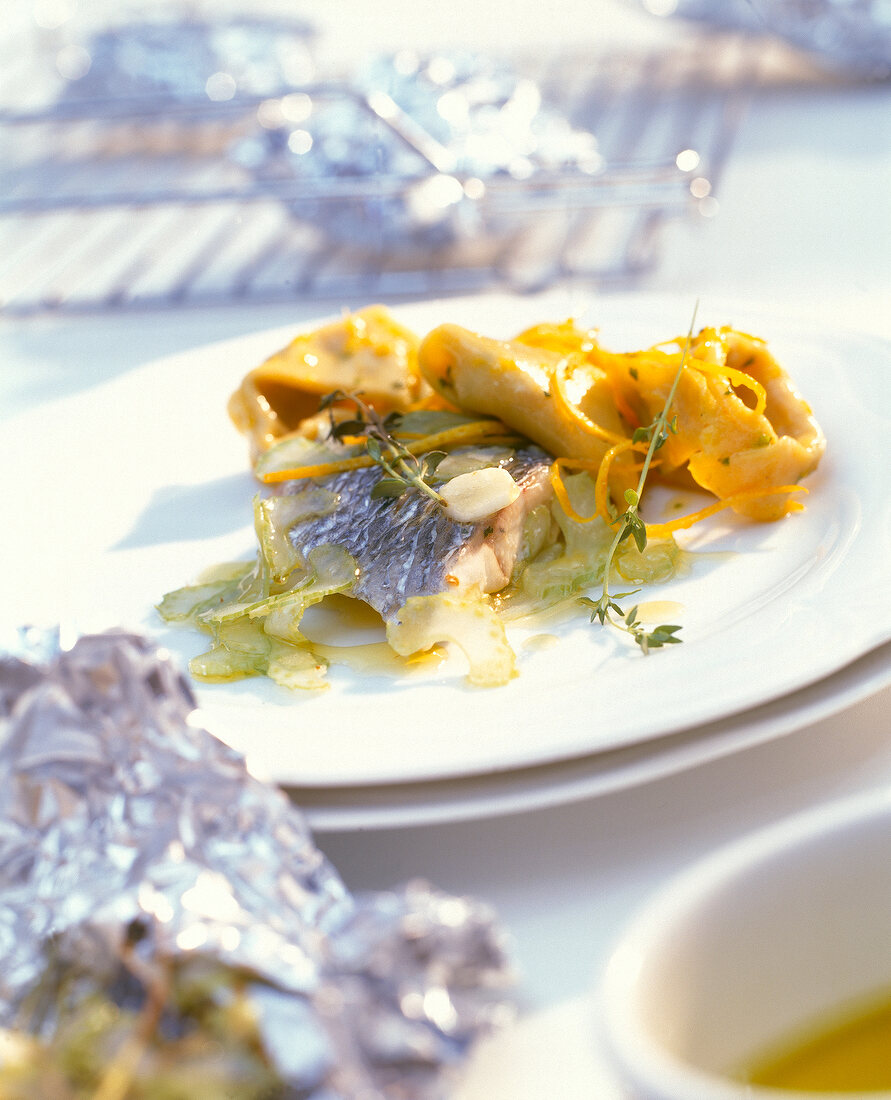 Fillet of sea bass cooked with tortellini on plate