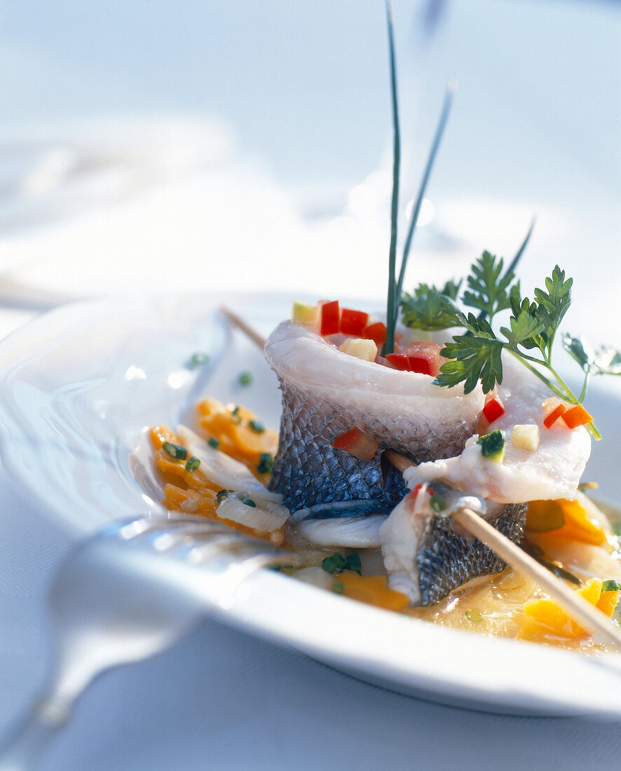 Pickled herring skewers and vegetables on plate