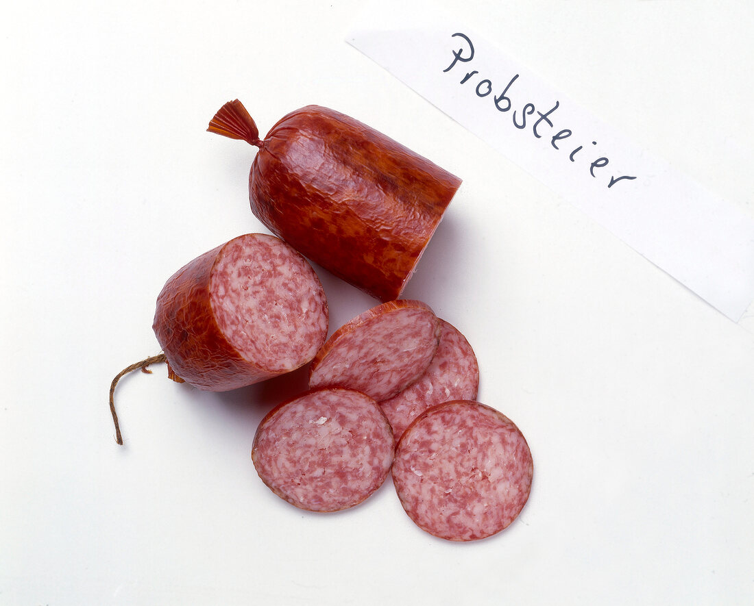 Sliced halves of sausages on white background