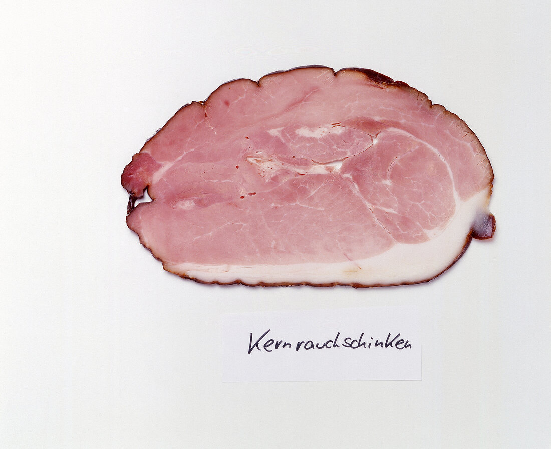 Slice of smoked ham on white background