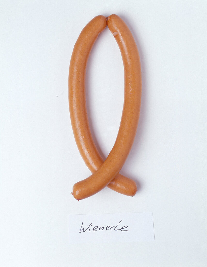 Close-up of two polish sausage on white background