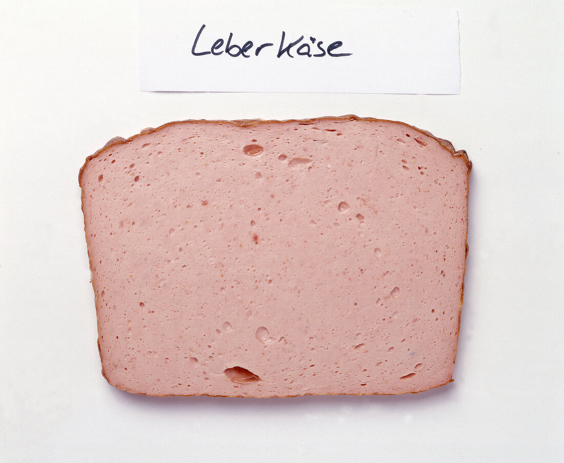 Slice of liver cheese on white background