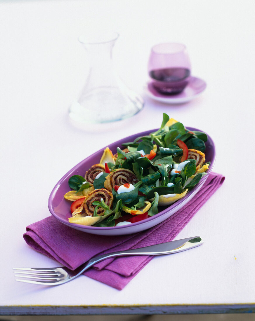 Corn salad with olive crepes in bowl