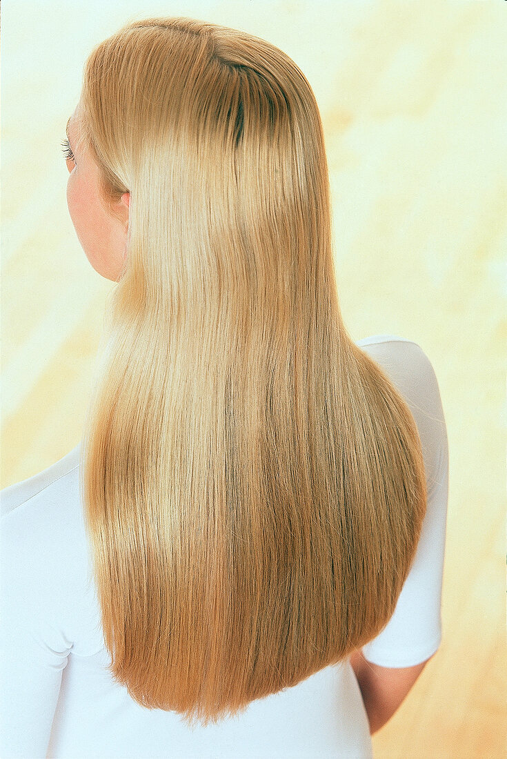 Rear view of blonde woman with long glossy straight hair