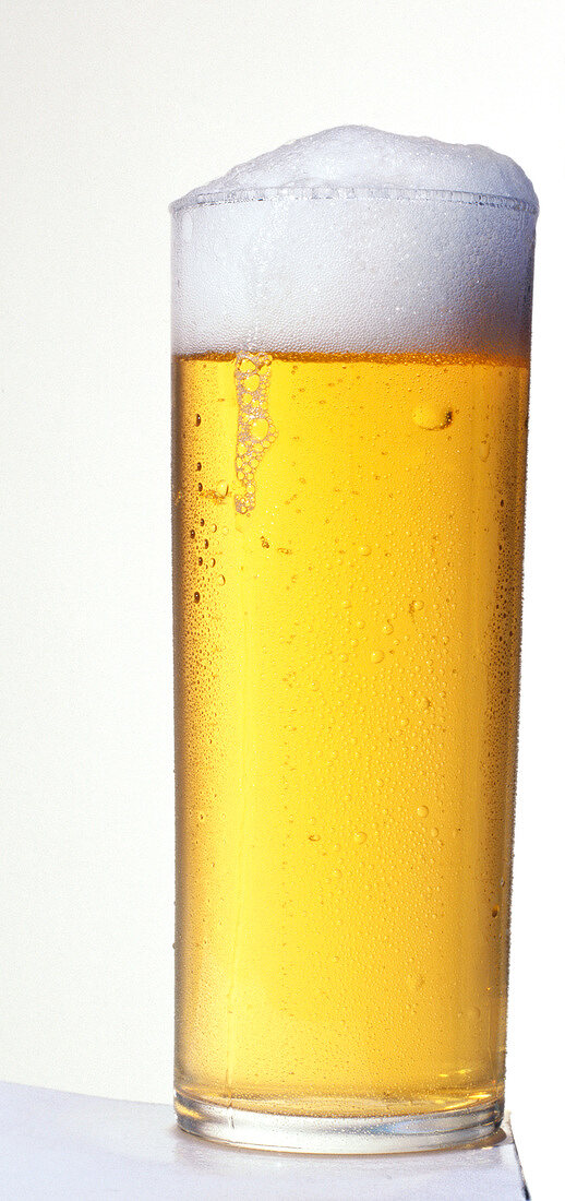Glass of beer with froth, close-up