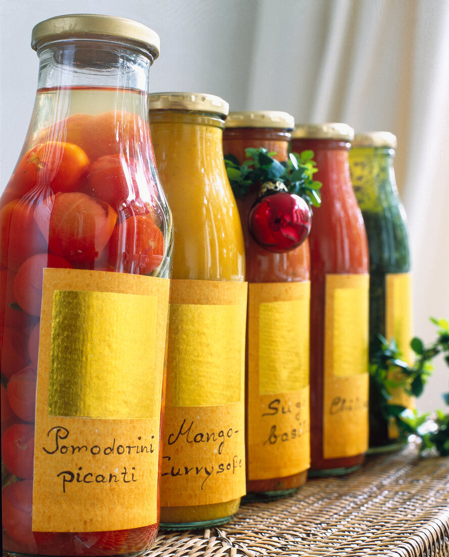 Close-up of bottles of pickle, tomatoes and sauces