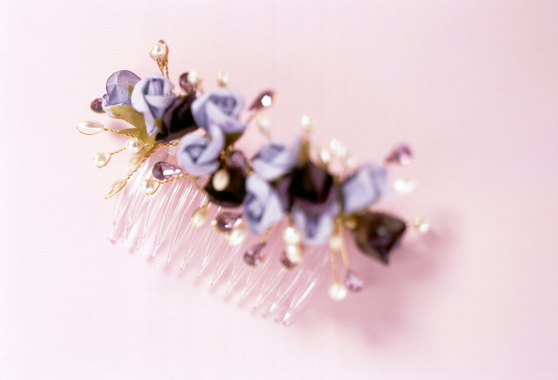 Close-up of decorated barrette on pink background