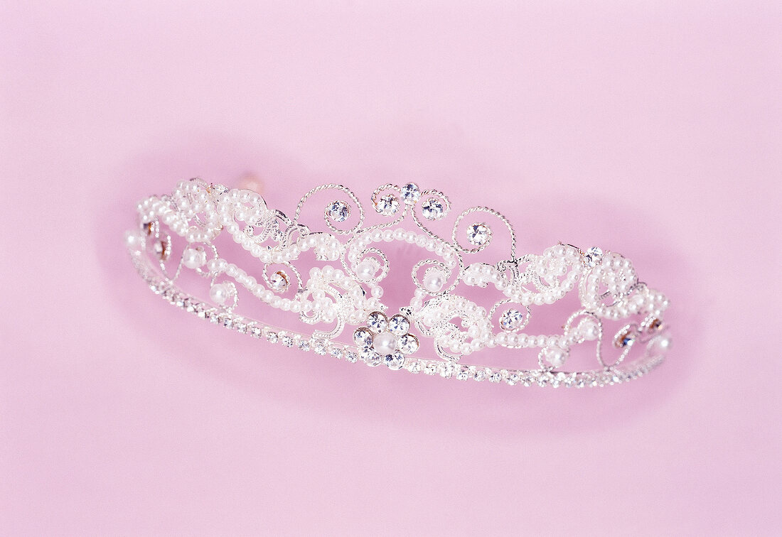 Close-up of beaded crown on pink background