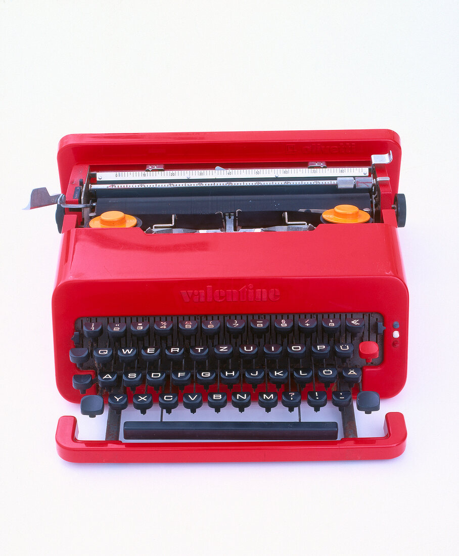 Red typewriter on white background