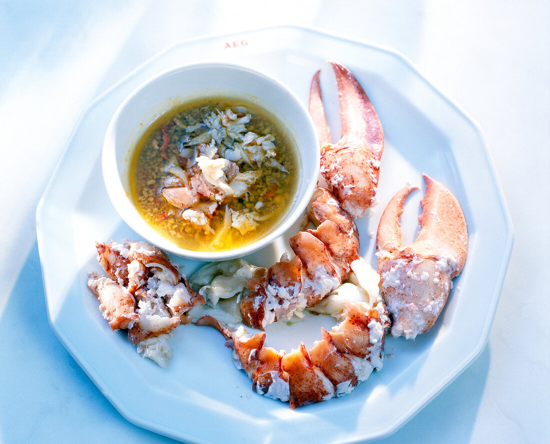 Lobster meat and lobster broth on plate