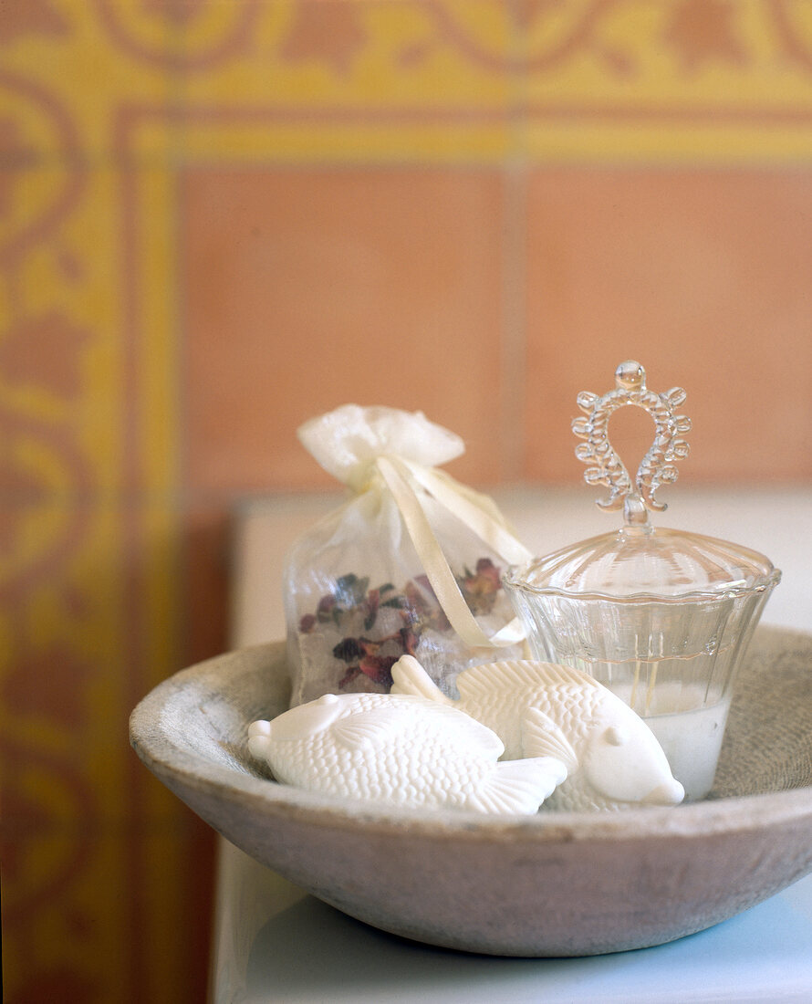 Close-up of fish shaped soaps with bath salts in bowl