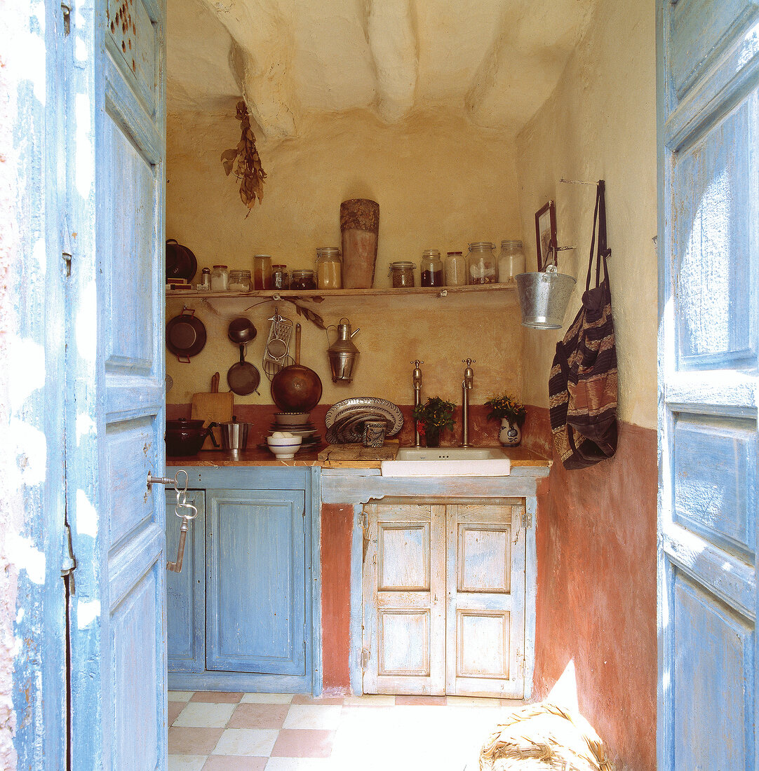 View of Italian house kitchen through open door, Italy