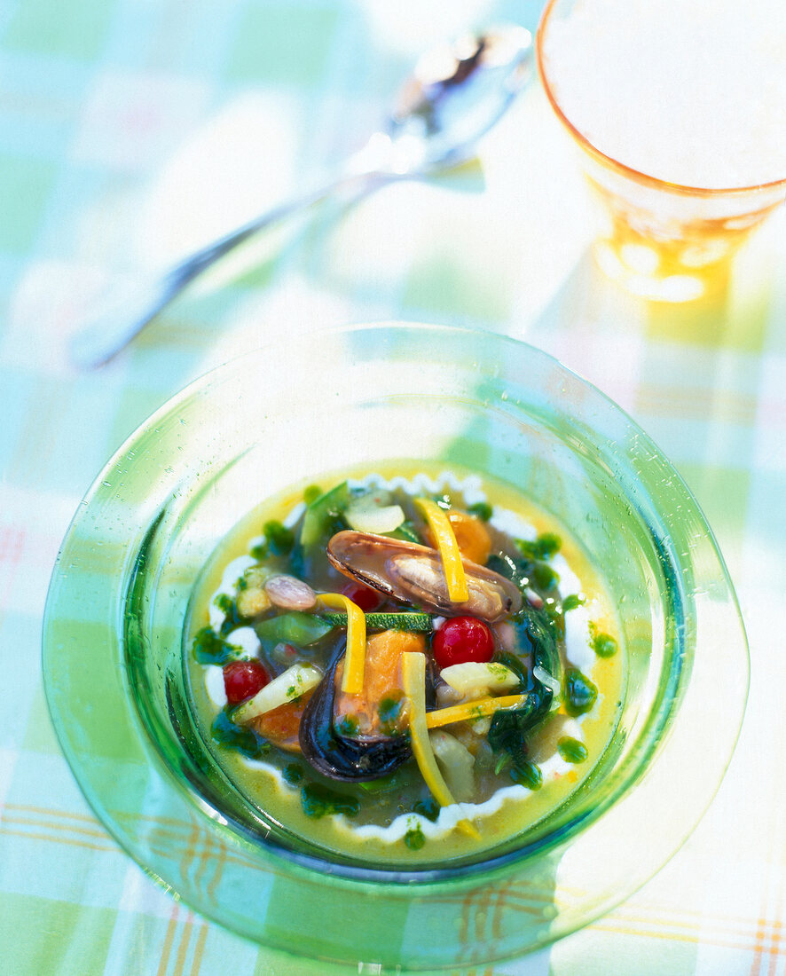 Gelled minestrone with mussels in glass bowl