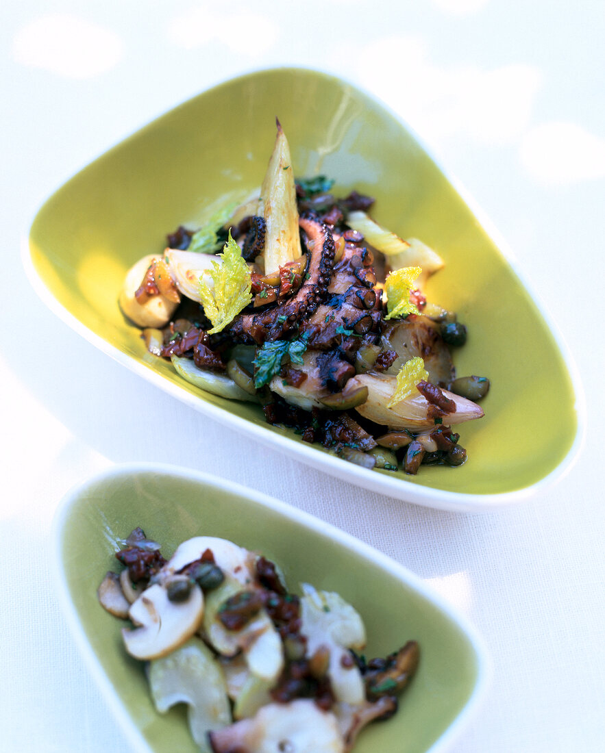 Salad with octopus in triangular bowl