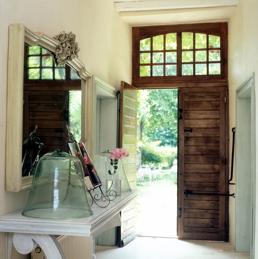 Hallway with pantry, glass bell and door to garden