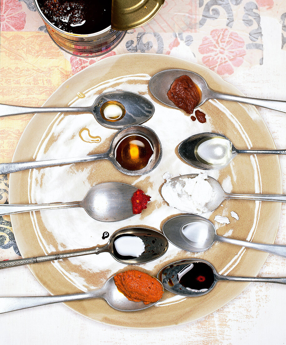 Various Asian ingredients on silver spoons