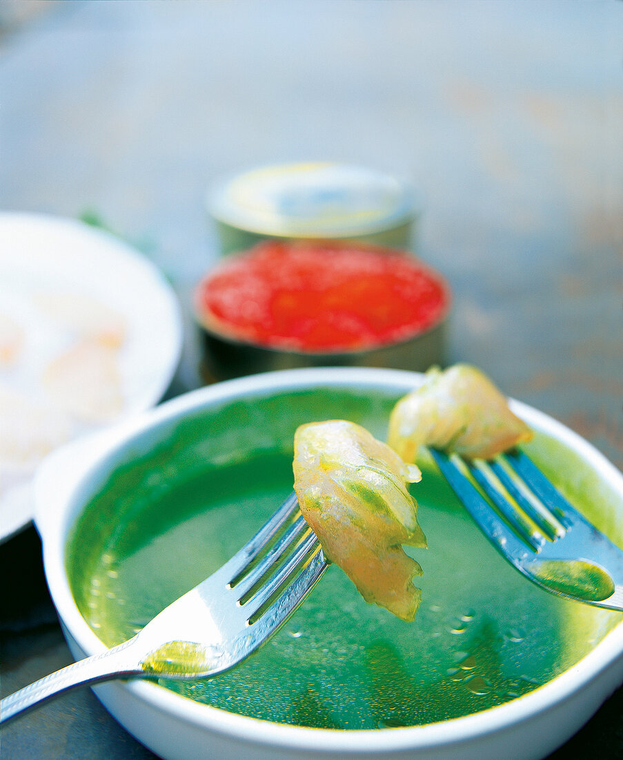 Mackerel with cucumber and lettuce vinaigrette in bowl with fork