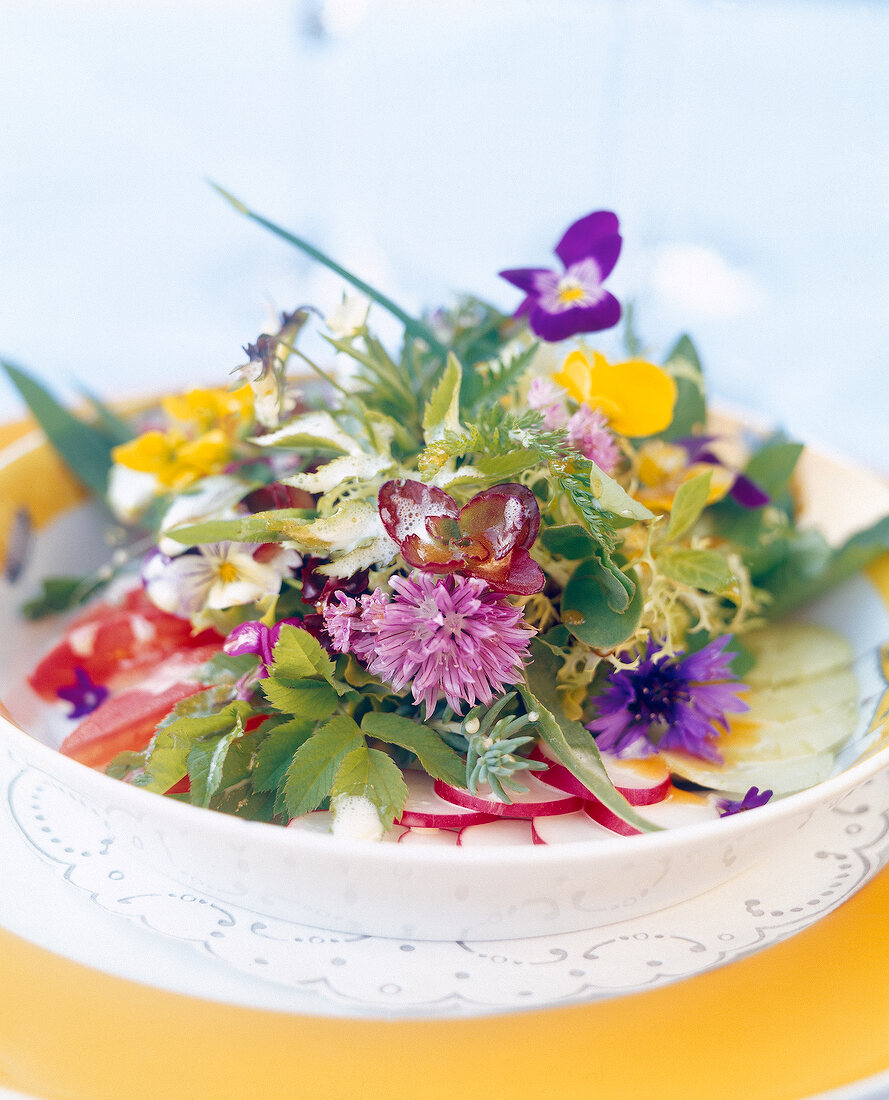 Close-up of salad with colourful herb on plate