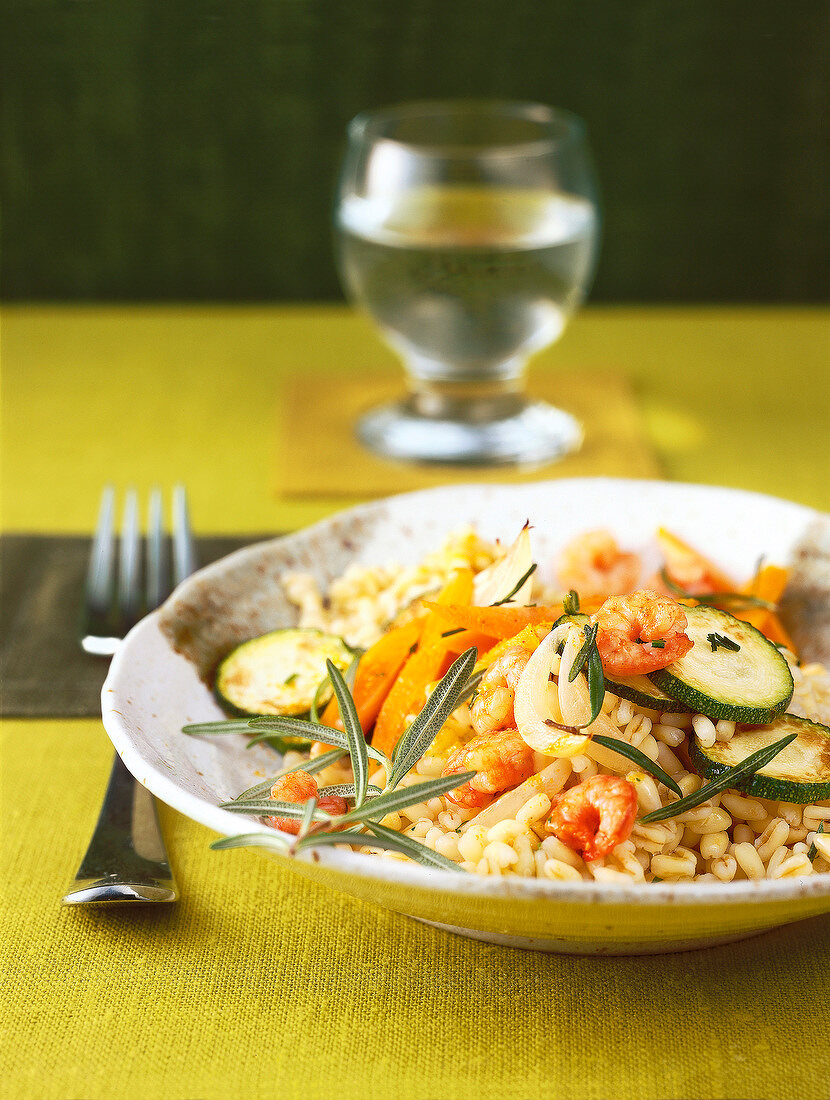 Close-up of pan fried vegetables with tender wheat and crab on plate