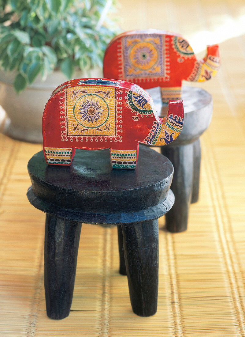 Asian style money boxes in elephant shape on stool