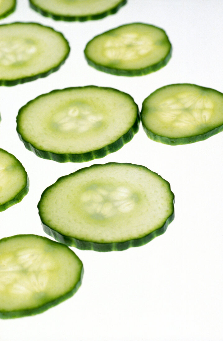 Close-up of cucumber slices on white background