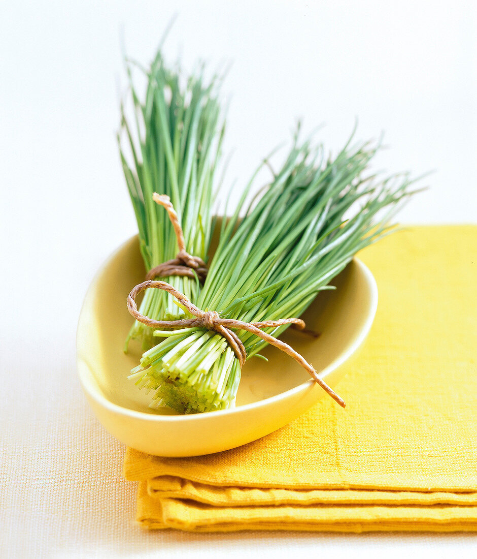 Close-up of two chive bunches in serving bowl