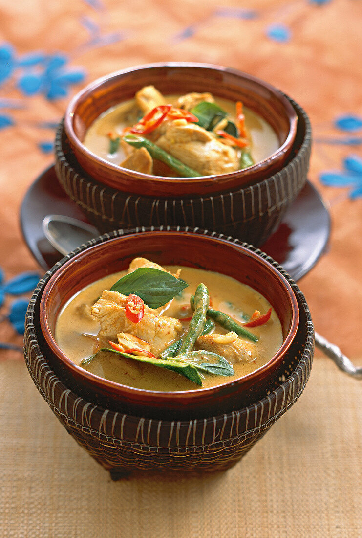 Close-up of Gaeng Panang Gai chicken curry with coconut in serving bowl