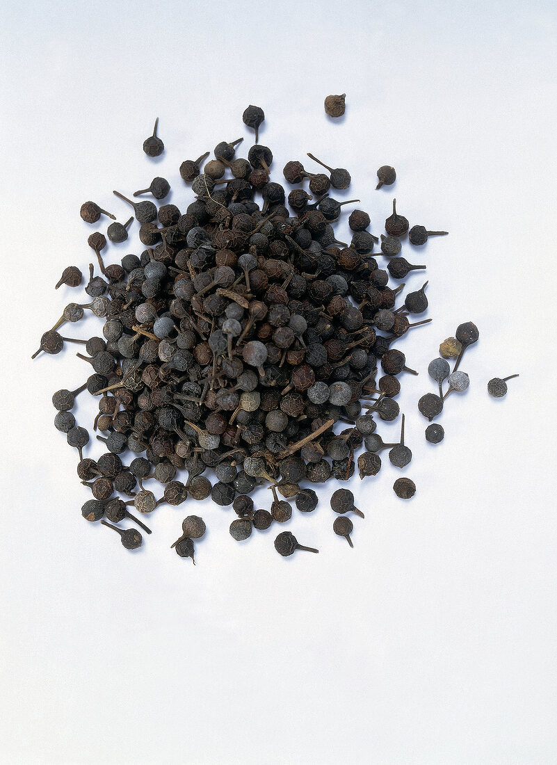 Cubeb peppercorns on white background