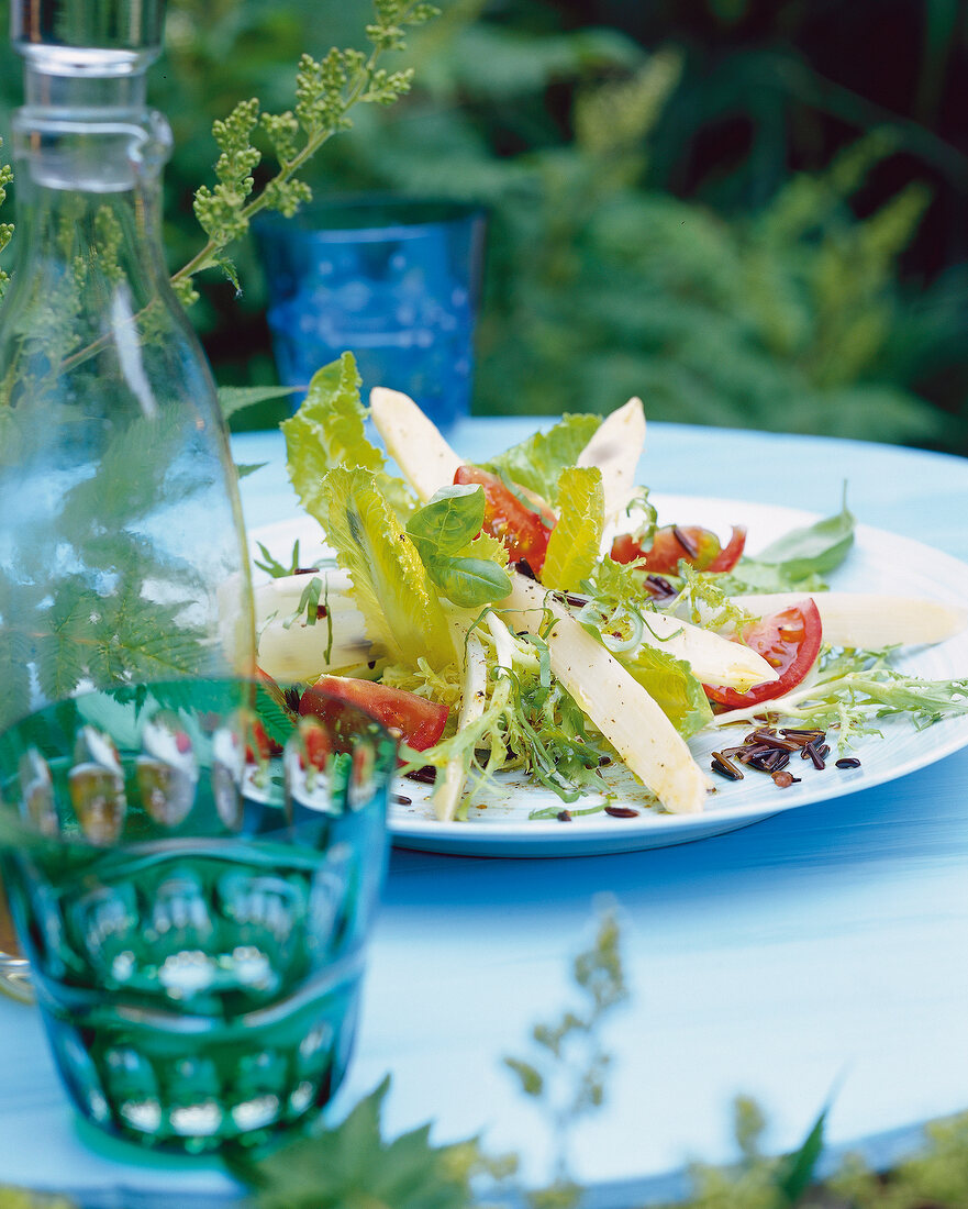 White asparagus and romaine lettuce with wild rice on plate