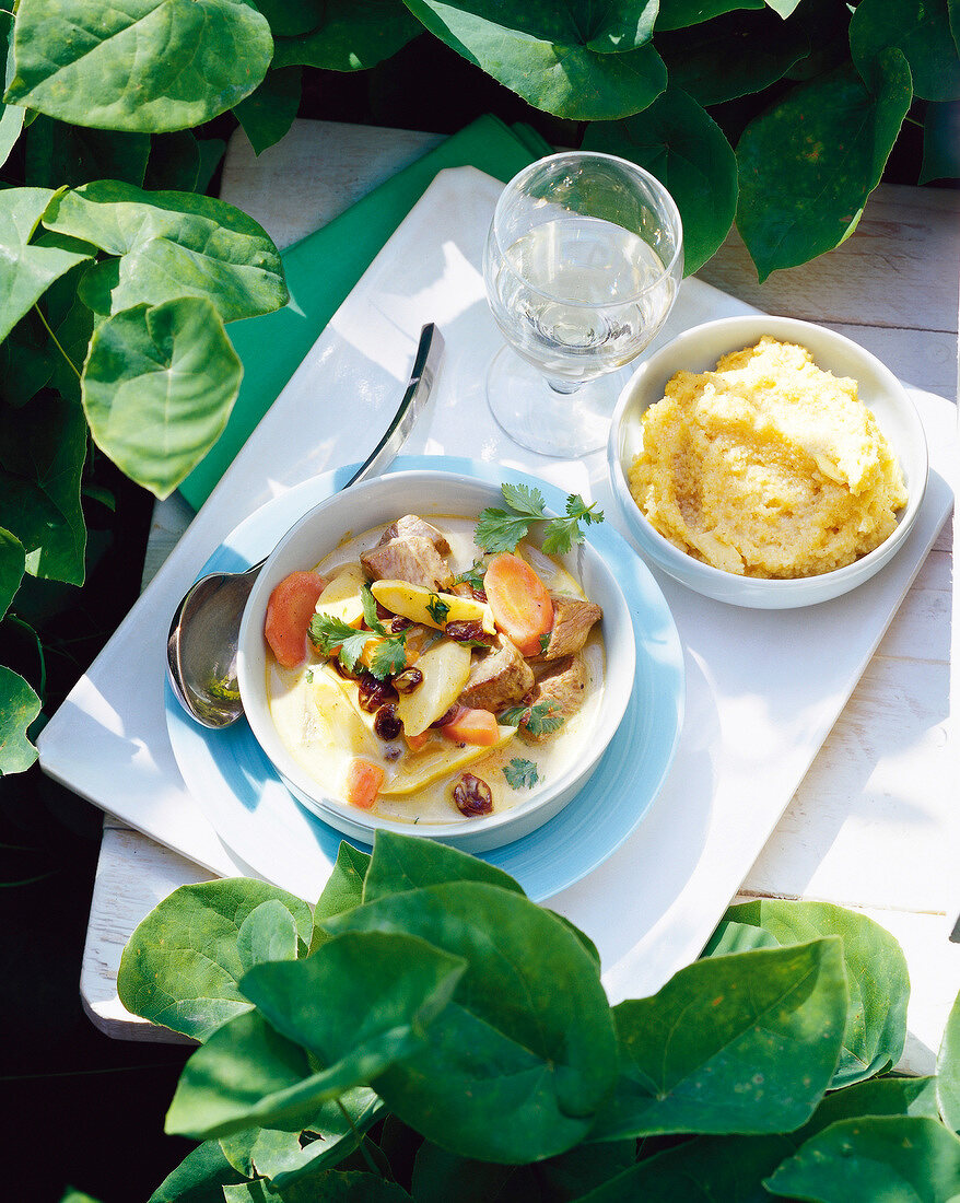 Asparagus curry with lamb and couscous in bowl