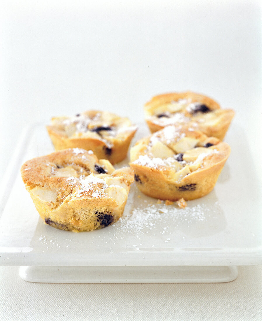 Close-up of slip cakes and pastries with plum apples and rum