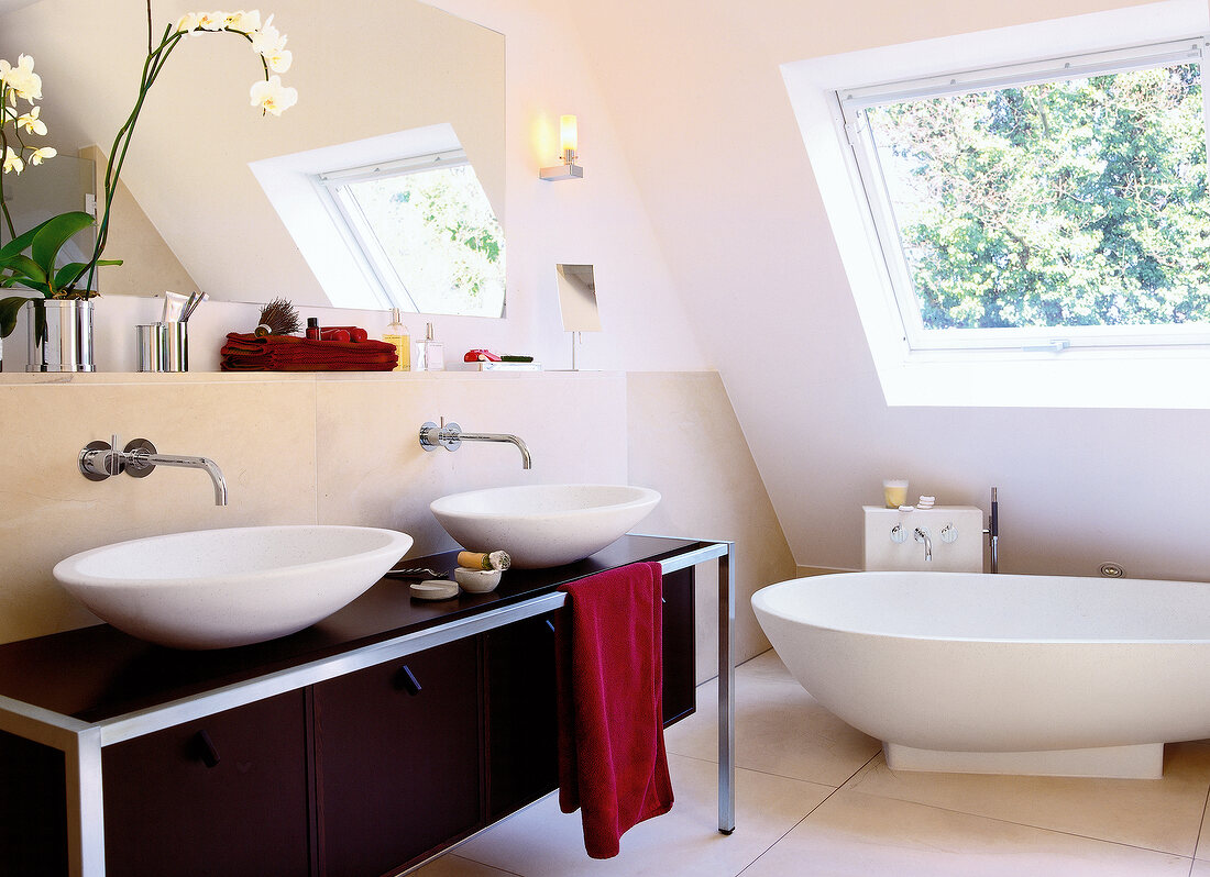 Bathroom with freestanding bathtub and round sink