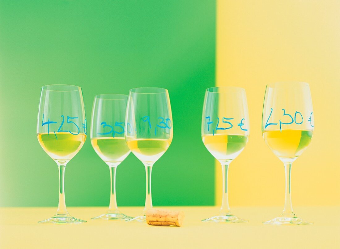 Glasses of white wine with prices written on them